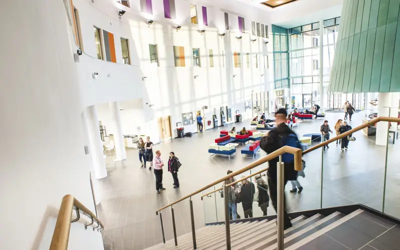 Inside view on Inverness College students on stairs